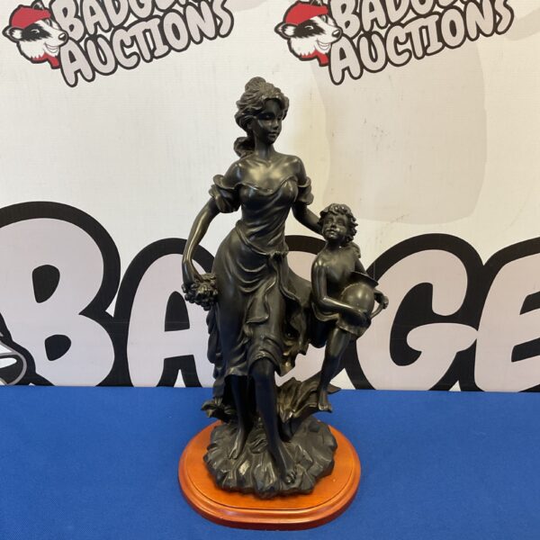 Elegant Art Nouveau sculpture of a woman and child in bronzed resin.