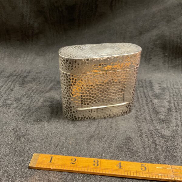Antique Arts and Crafts silver box with textured surface.