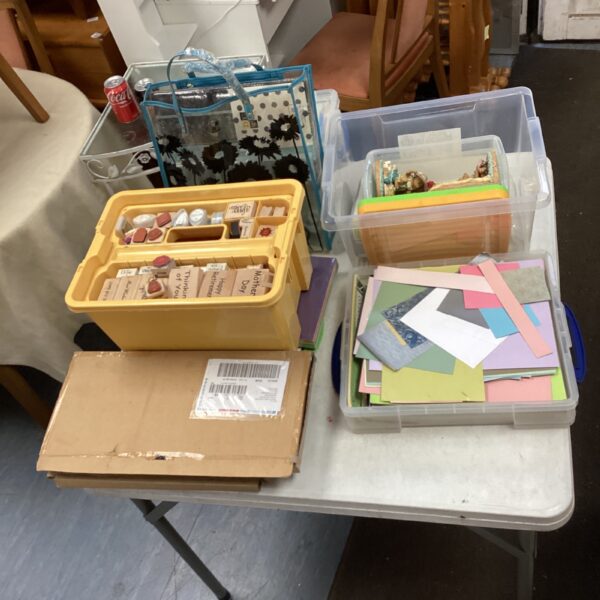 Assorted arts and crafts supplies in a plastic container.