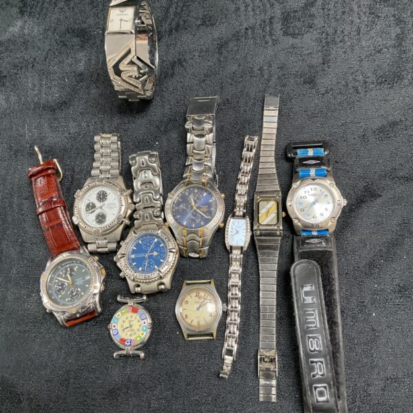 Tray of assorted quartz wristwatches, vintage and modern styles.