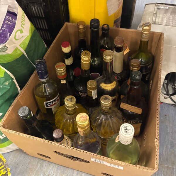 Mixed lot of assorted open spirit bottles and miniatures.