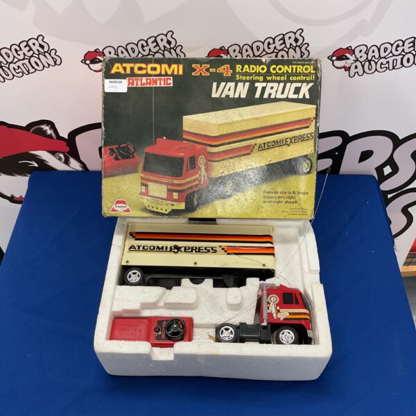 Vintage Atcomi X-4 radio control van toy with steering wheel.