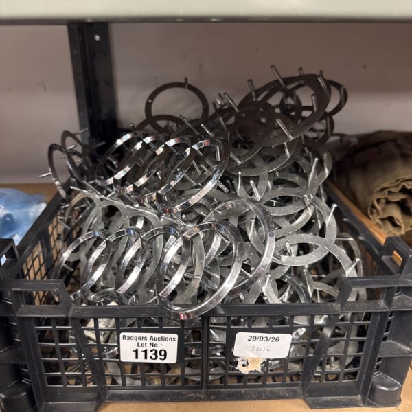 Tray of Audi ring badges for automotive restoration.