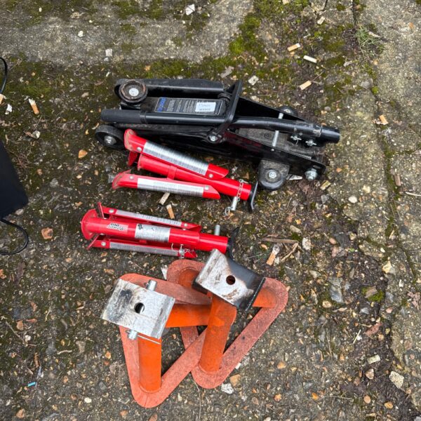 Axle stands and trolley jack set for vehicle maintenance.