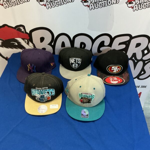 Selection of baseball caps including a New York Nets cap.