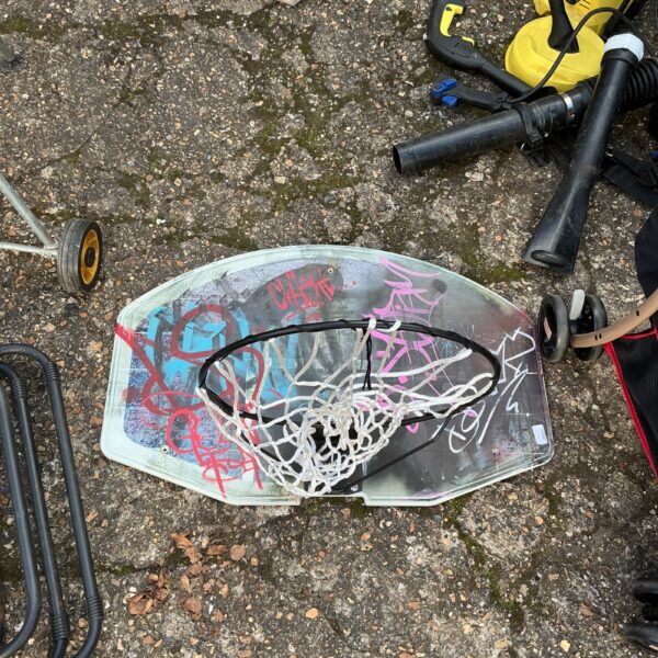 Used basketball hoop backboard showing wear and tear.