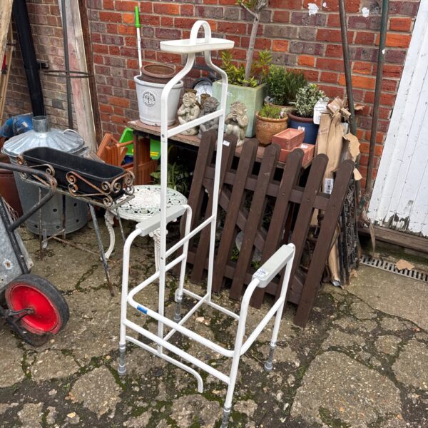 Metal bathroom support frame with adjustable height and castors.