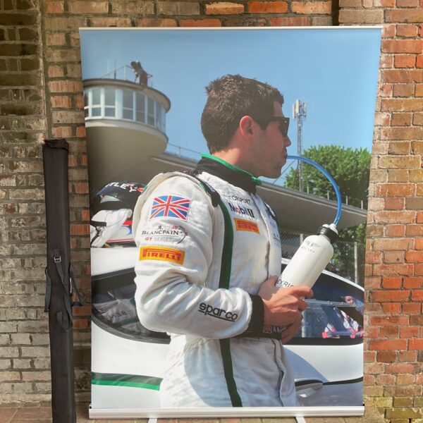 Bentley Motor Racing display screen featuring a racing driver.