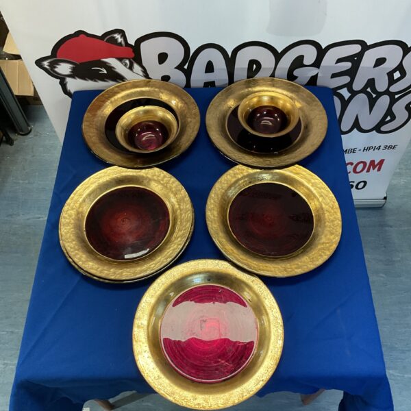 Vintage BHS red and gold glass plates and bowls on display.