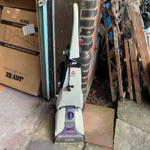 Vintage Bissell Cleanview carpet cleaner for home floor cleaning.