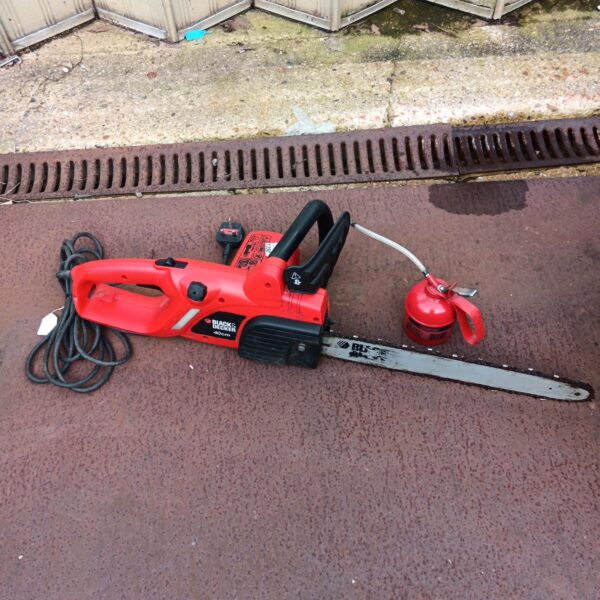 Used Black & Decker 40cm electric chainsaw with oil for garden work.