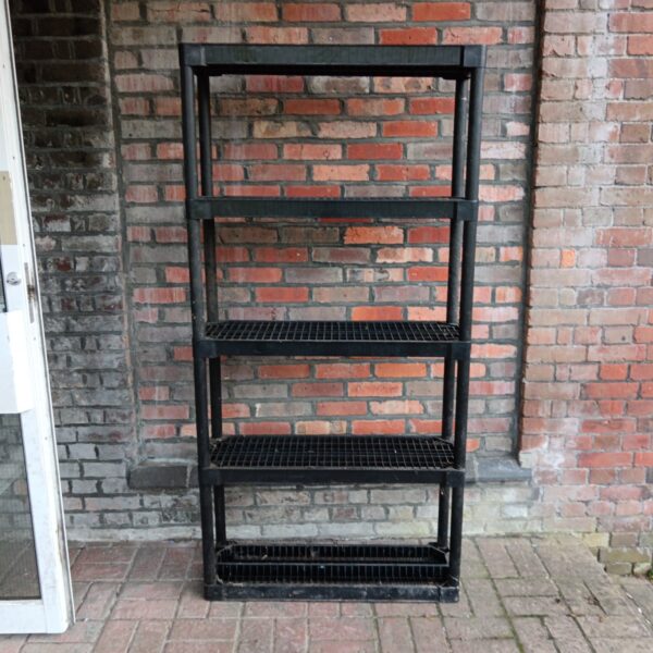 Black plastic shelving unit with five tiers for storage.