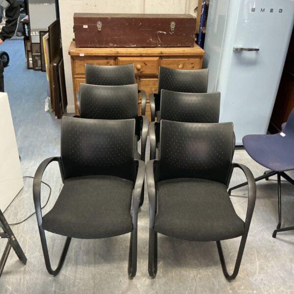 Lot of six black reception chairs for office or waiting room use.