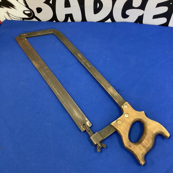 Vintage 1942 Black Sellars veterinary saw with curved blade.
