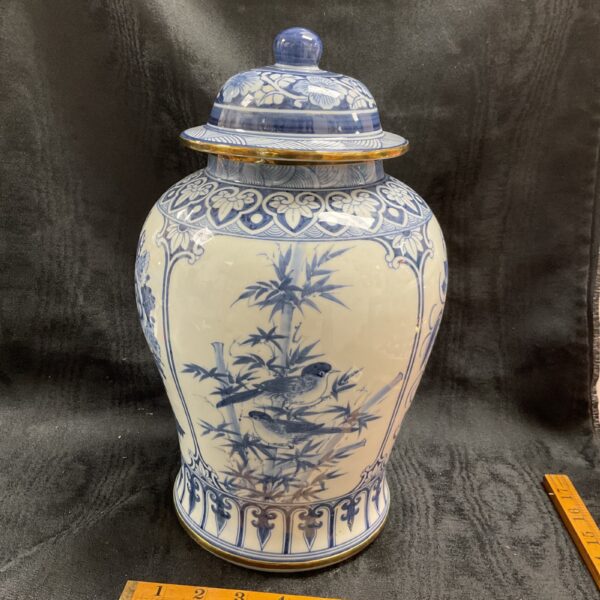 Antique blue and white temple jar with bird and bamboo design.