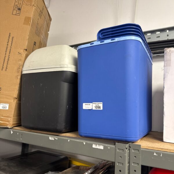 Blue cooler boxes stacked, ideal for picnics and outdoor use.