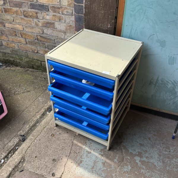 Blue engineering tool station with multiple drawers for parts storage.