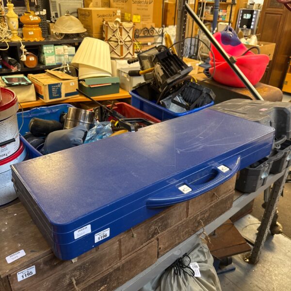 Blue plastic folding picnic table on a wooden table.