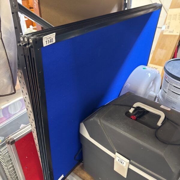 Blue office divider screen for creating private workspaces.
