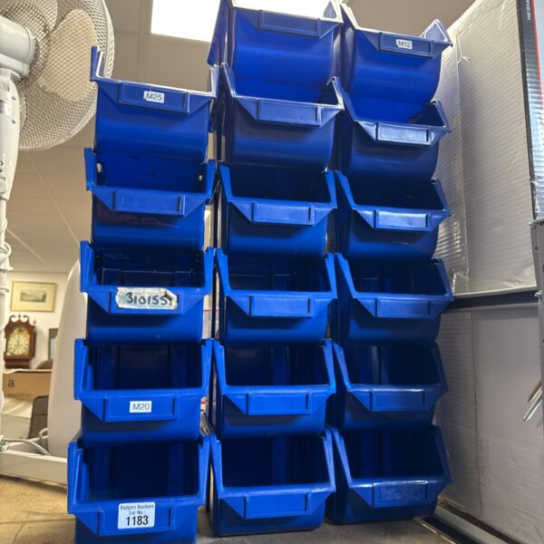 Stack of blue plastic storage containers for garage or workshop.