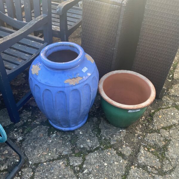 Vibrant blue and terracotta glazed garden pots for outdoor plants.