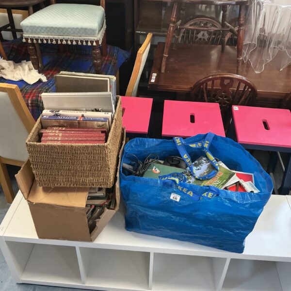 Mixed book lot including WWII history books in a basket.