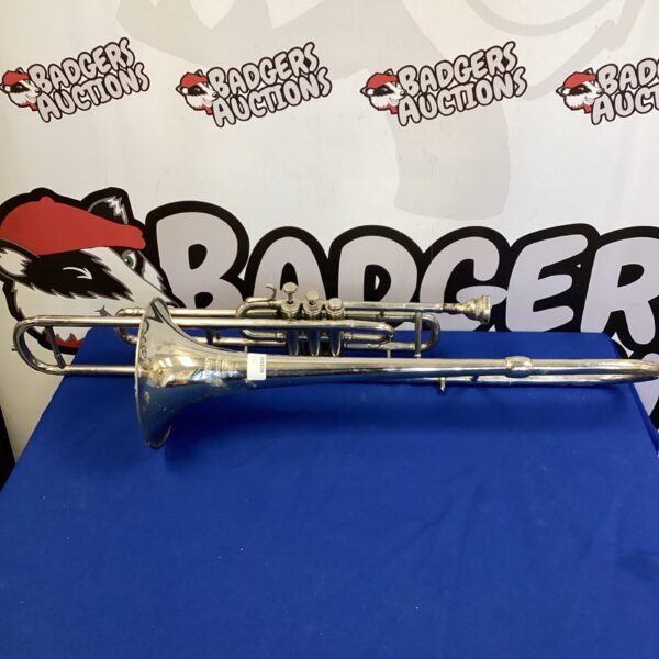 Vintage Boosey Besson trombone in brass, side view.