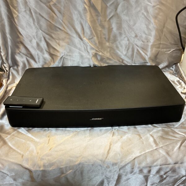 Black Bose Solo TV sound system with remote control.