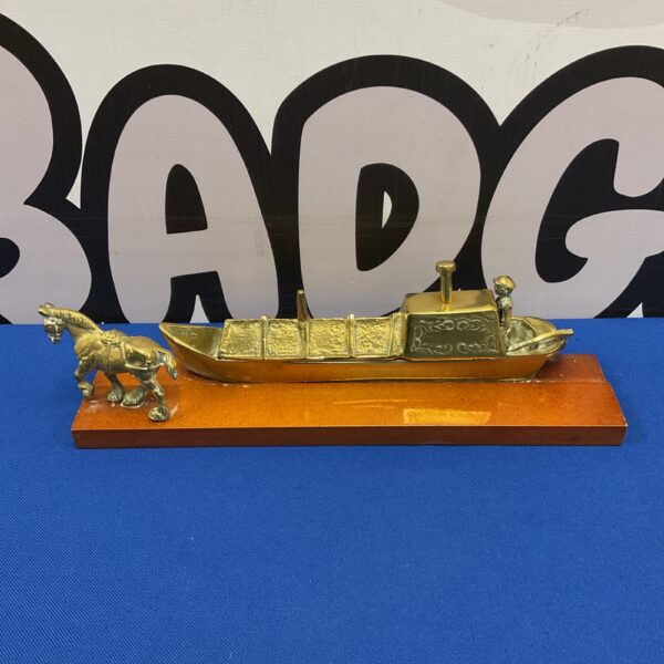 Vintage brass canal barge with horse on wooden base.