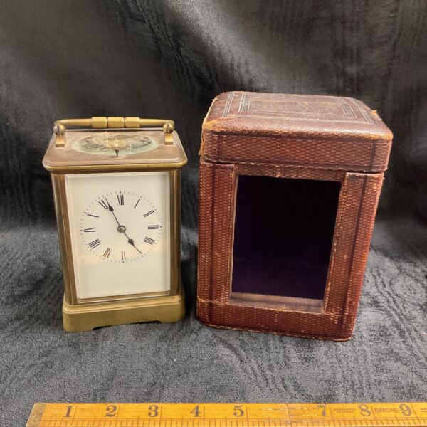 Antique brass carriage clock with its original travel case.