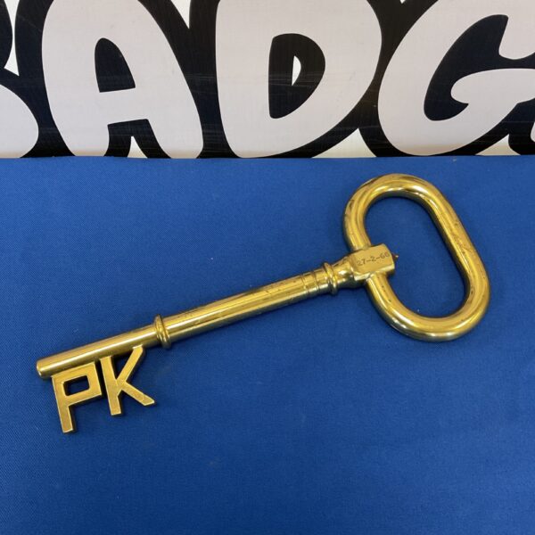 Large vintage brass PK key with intricate detailing.