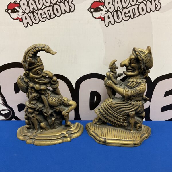 Vintage brass Punch and Judy doorstops, a charming collectible pair.