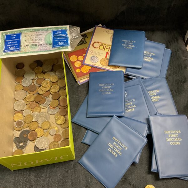 Britain’s first decimal coin folders and a tub of assorted vintage coins.