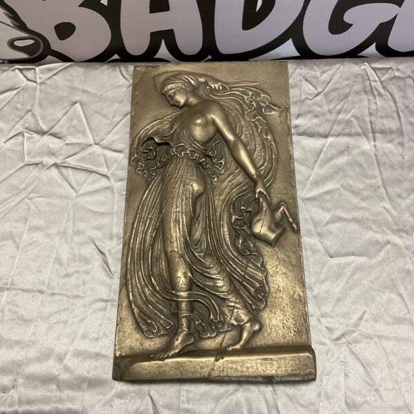 Art Deco bronze plaque depicting a female figure.