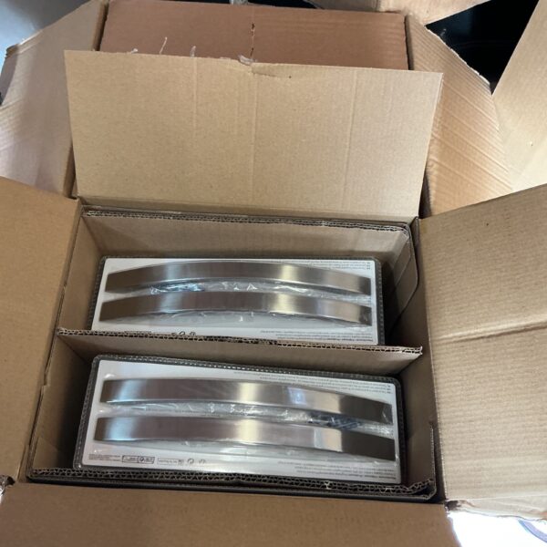 Quantity of brushed steel door handles in original packaging.
