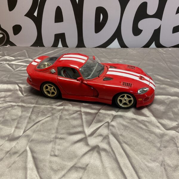 Red Burago Dodge Viper GTS diecast model car on display.