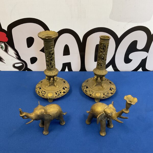 Antique Burmese candlesticks with elephant designs, detailed brass work.