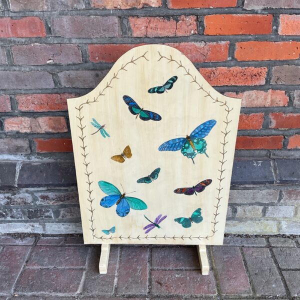 Vintage butterfly fire guard with colourful decoupage design.
