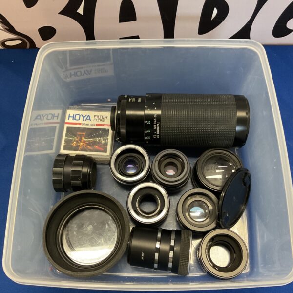 Tray of vintage camera lenses and accessories, including a Tamron lens.