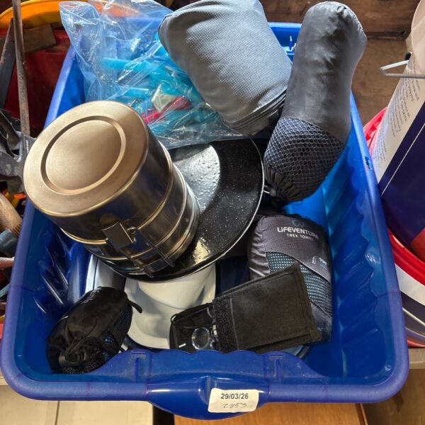 Camping equipment lot with a Trek towel and various outdoor items.