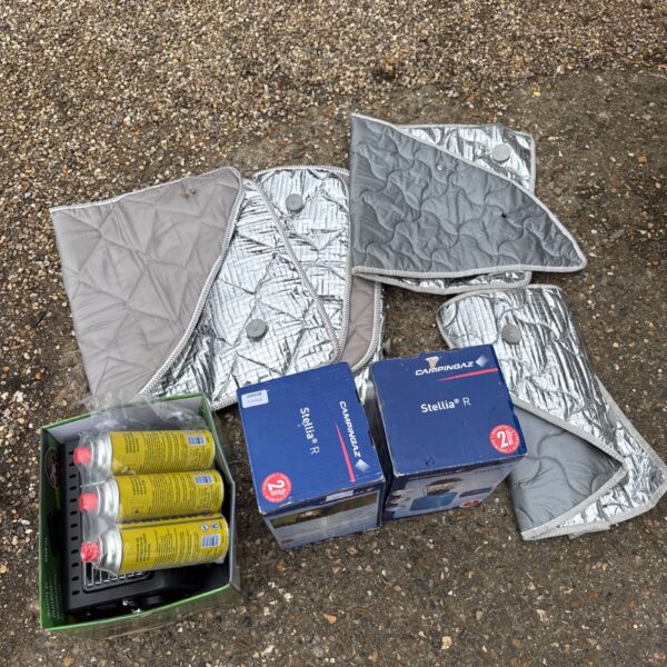 Camping equipment lot including lanterns and heater.