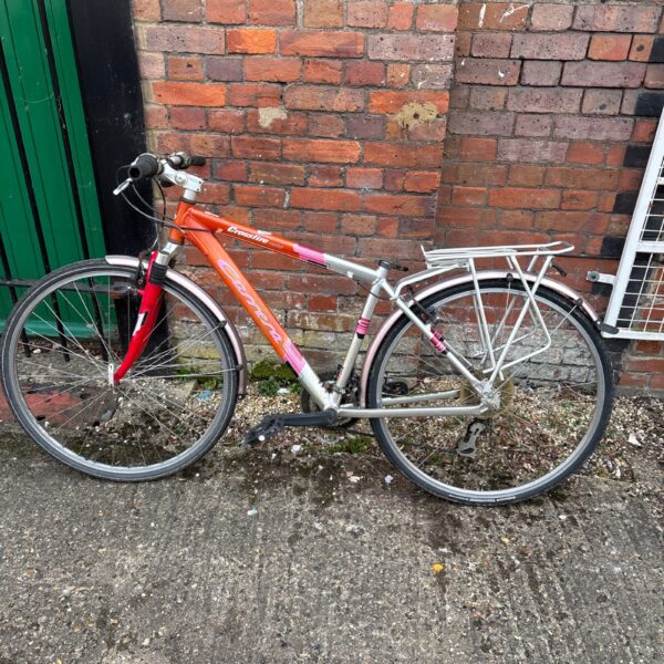 Red Carrera Crossfire 1000 mountain bike, side view.