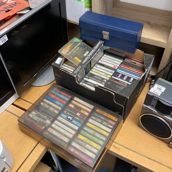Vintage cassette tape and CD collection in a plastic case.