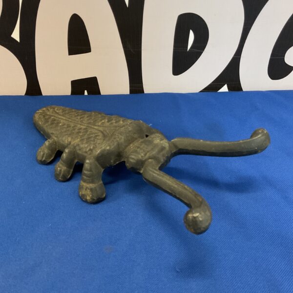 Vintage cast iron beetle boot remover for garden or porch.