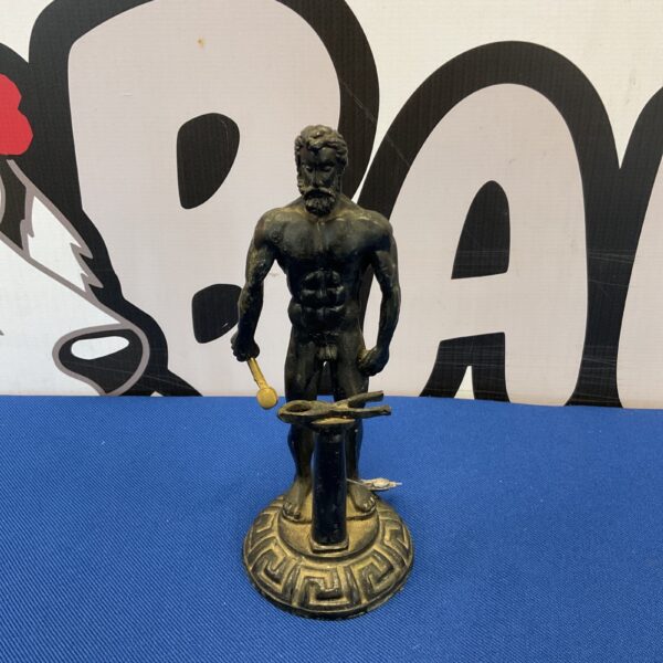 Vintage cast iron blacksmith figure, detailed mythological sculpture.