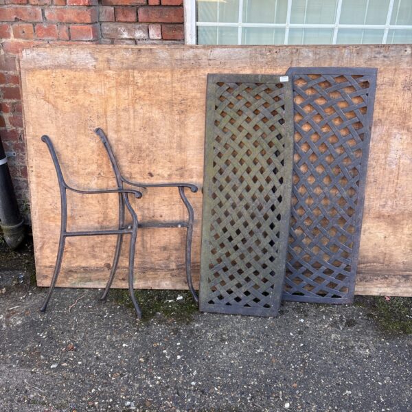 Antique cast iron garden bench with intricate Victorian design.