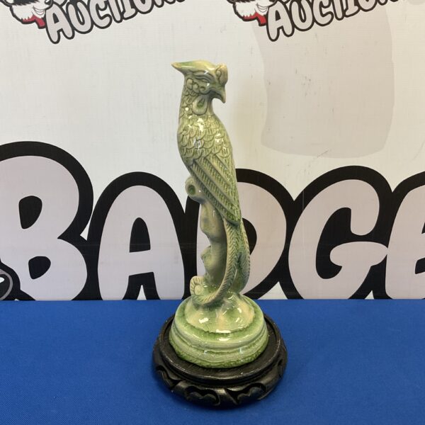 Vintage celadon bird of paradise sculpture on wooden base.