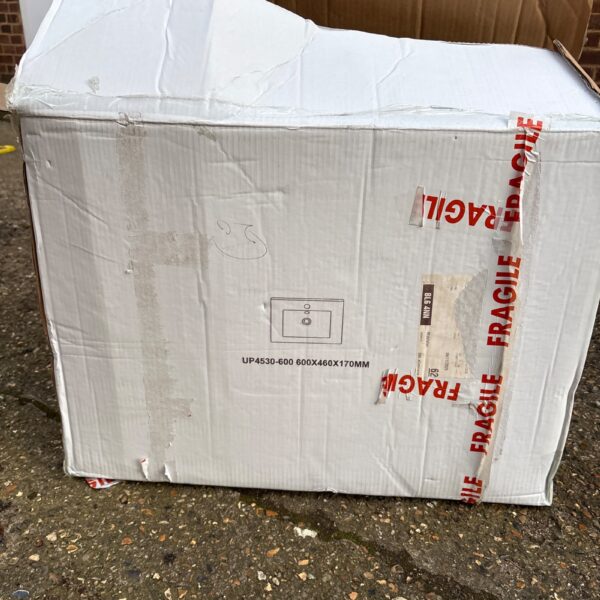 Ceramic bathroom sink in original packaging, ready for installation.