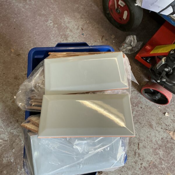 Quantity of neutral ceramic wall tiles for bathroom or kitchen renovation.