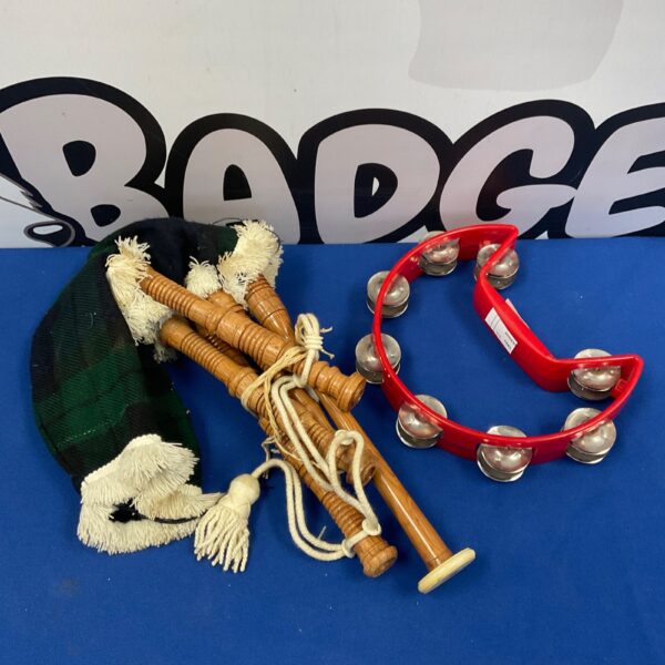 Vintage children’s bagpipes and tambourine musical instrument set.